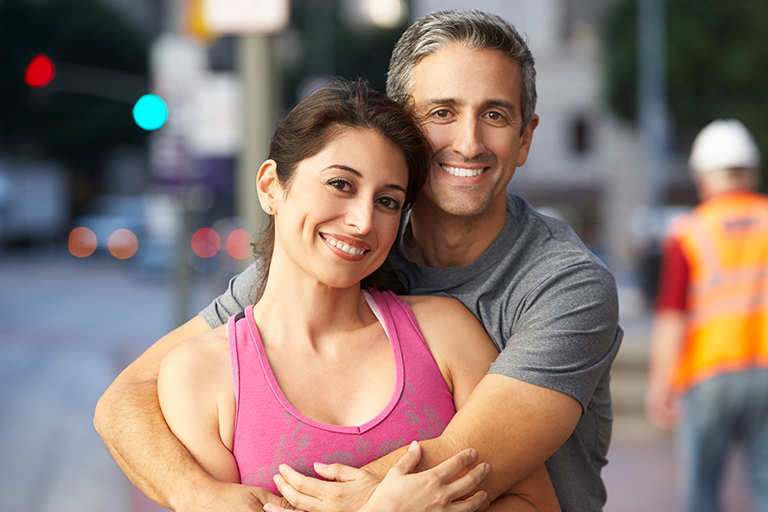 Portrait Of Male And Female Runners On Urban Street